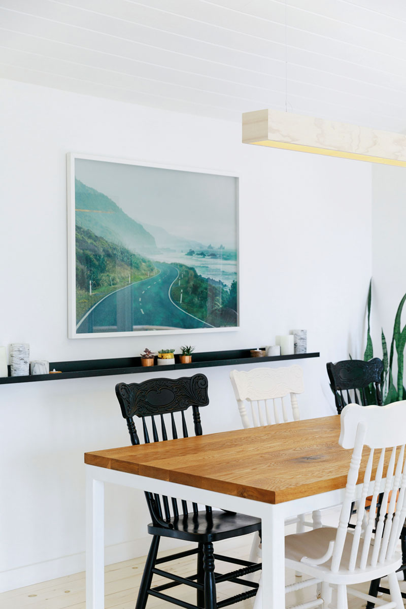 painted black and white dining chairs in Raina and Wilson's shared cottage