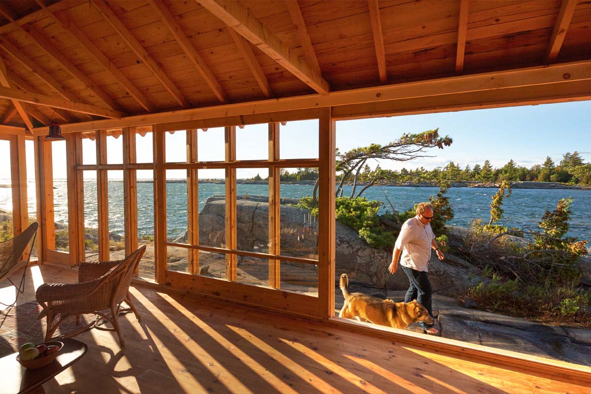 interior of a cottage with a large wall-sized window that rolls open