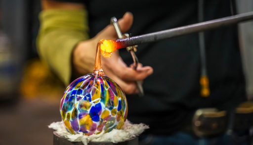 glass blower shaping an orb