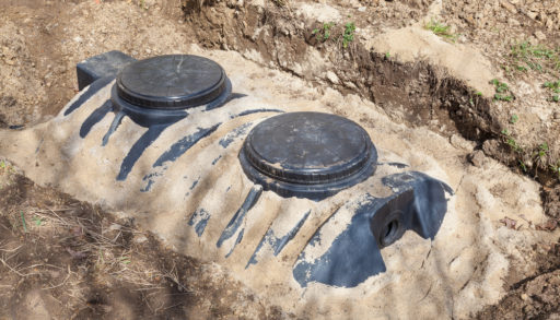 A septic tank buried in sand