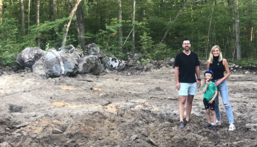 Danielle Bablich, her husband Paul Stanczak and their son Leo stand on the cottage building site