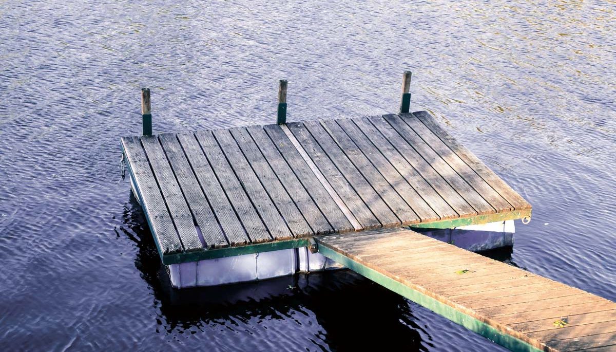 photo of a small floating dock on a lake with a ramp leading to it