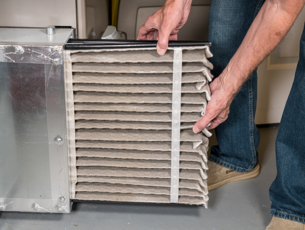 Male arms changing a dirty air filter