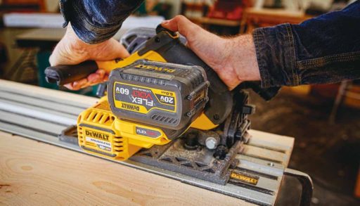 man using a track saw in a workshop