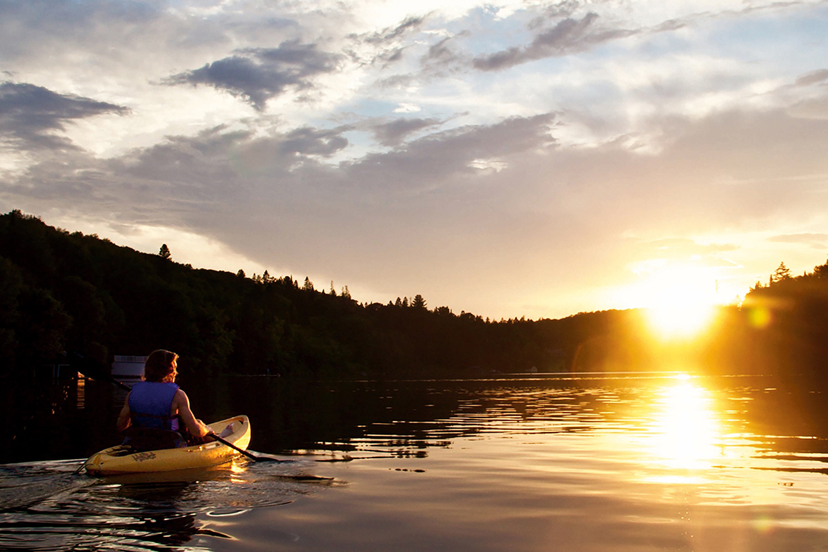 man in kayak at sunset