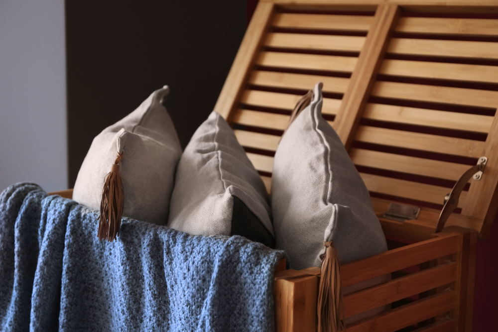 Pillows and a blanket stored in a wooden blanket box
