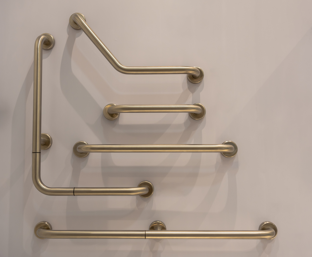 Several wall-mounted brass grab bars