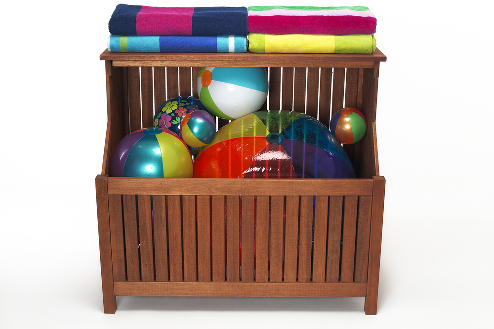 A storage bin filled with beach balls and towels