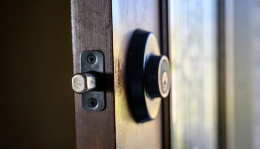 Close-up of a wooden door with a deadbolt lock with bolt extended