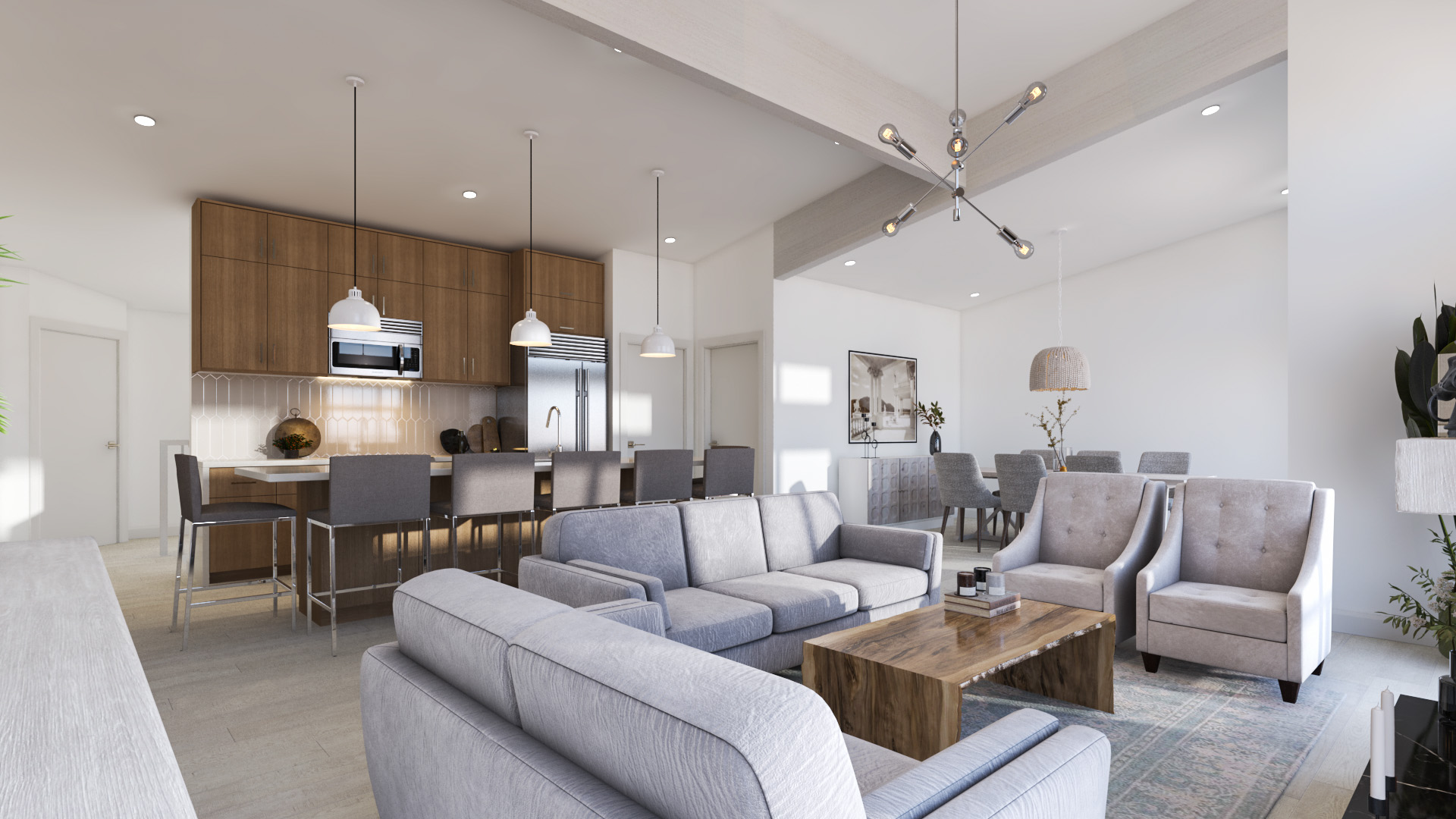A large indoor living area with grey couches, with an open concept leading to the kitchen and dining room.