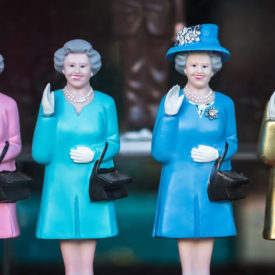 Four statues of Queen Elizabeth, waving.