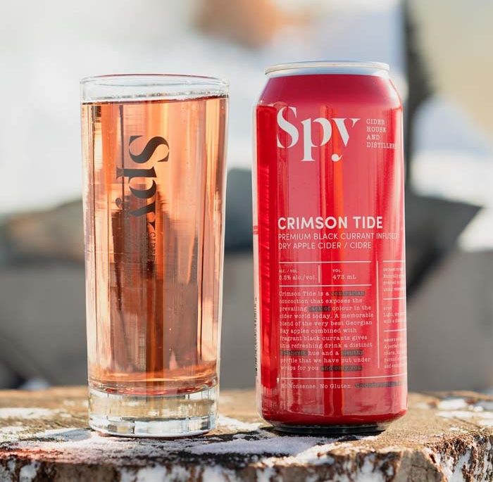 Spy Distillery Crimson Tide Cider on a tree stump