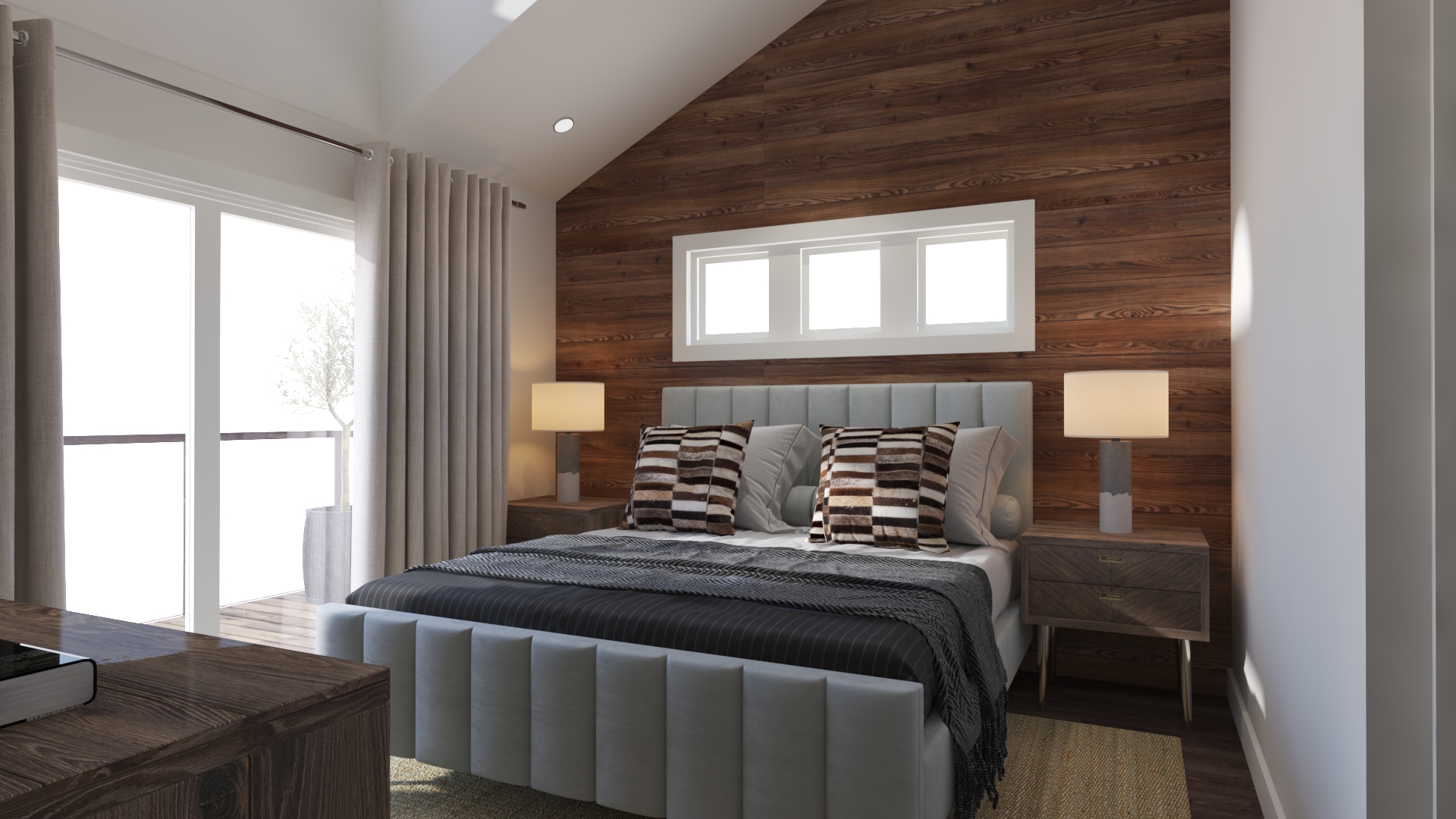 A large bedroom with a wood accent wall and big windows.