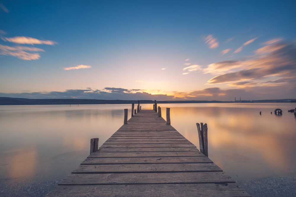 A long wooden dock at sunset