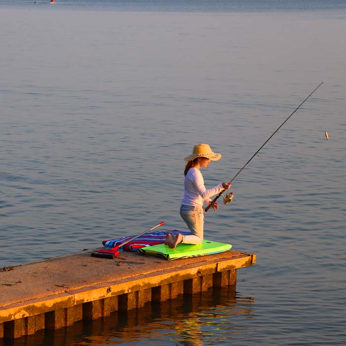 Our granddaughter just finished swimming with her puppy, went and changed and grabbed her fishing pole to get every last moment of fun as the sun begins to set.