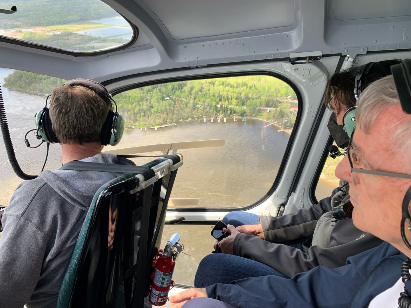 Helicopter cockpit above the Manitoba flood waters
