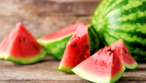 Slices of watermelon against a wood background
