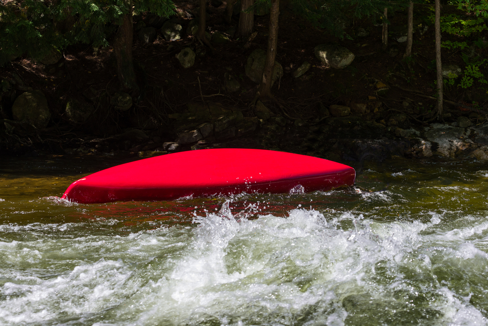 Overturned canoe in the water