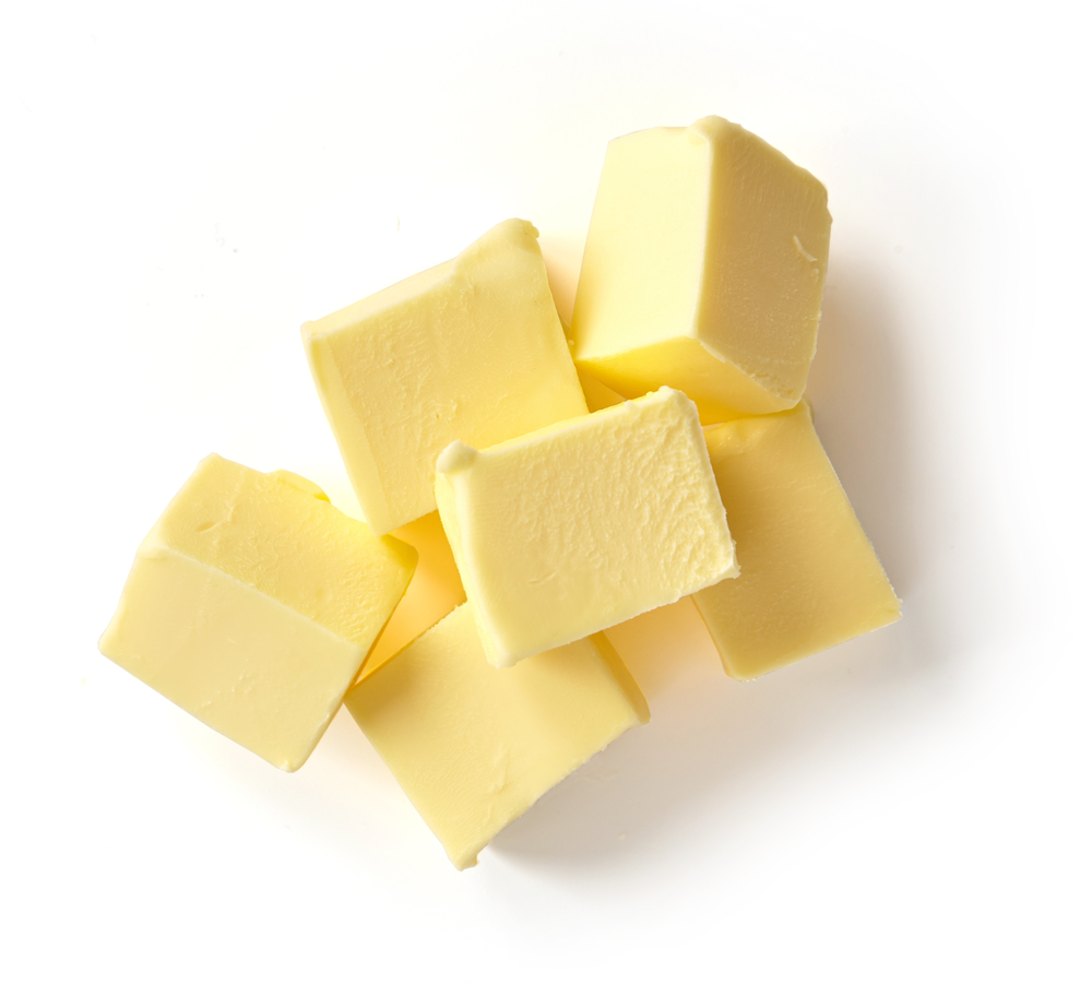 Pieces of butter against a white background