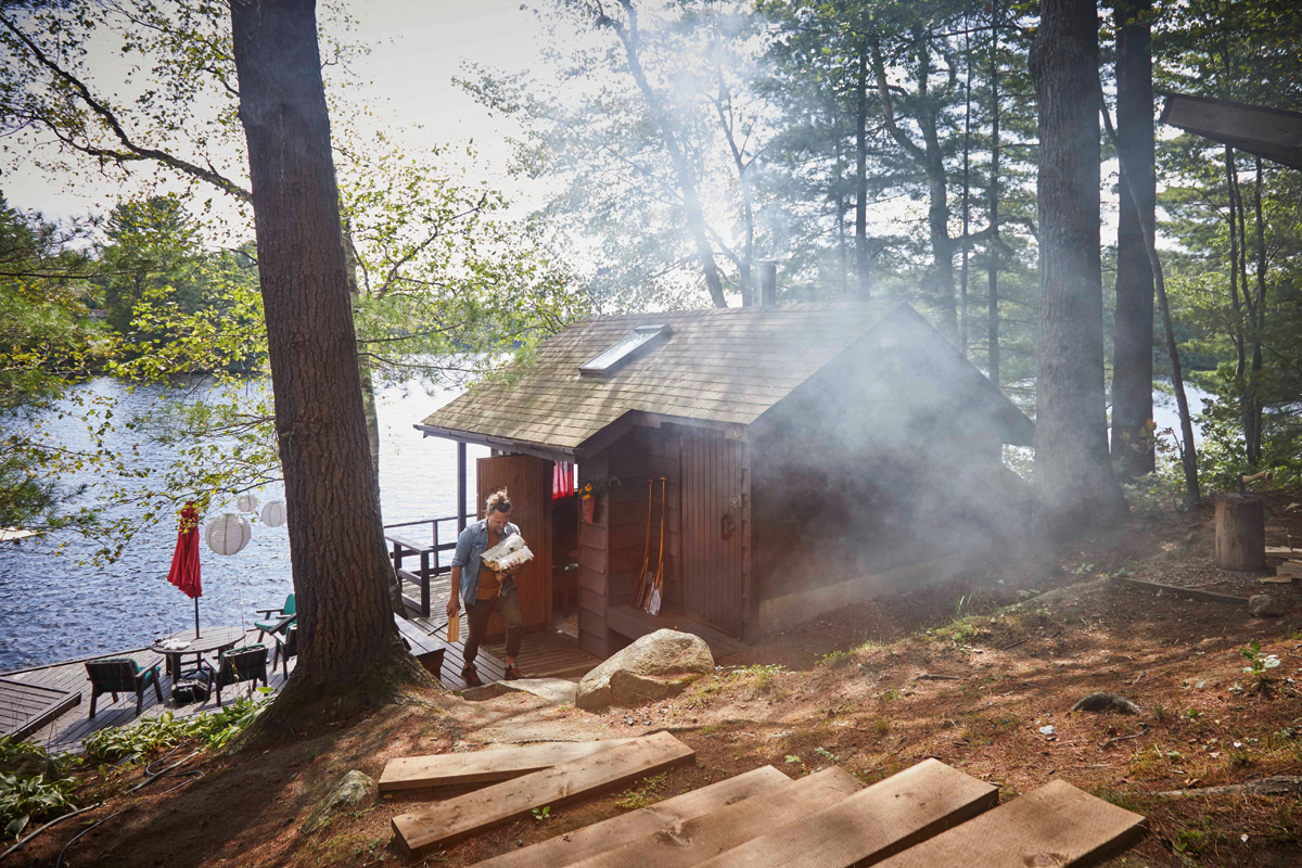 a view of the Finnish sauna looking down to the lake with steam rising out of the building