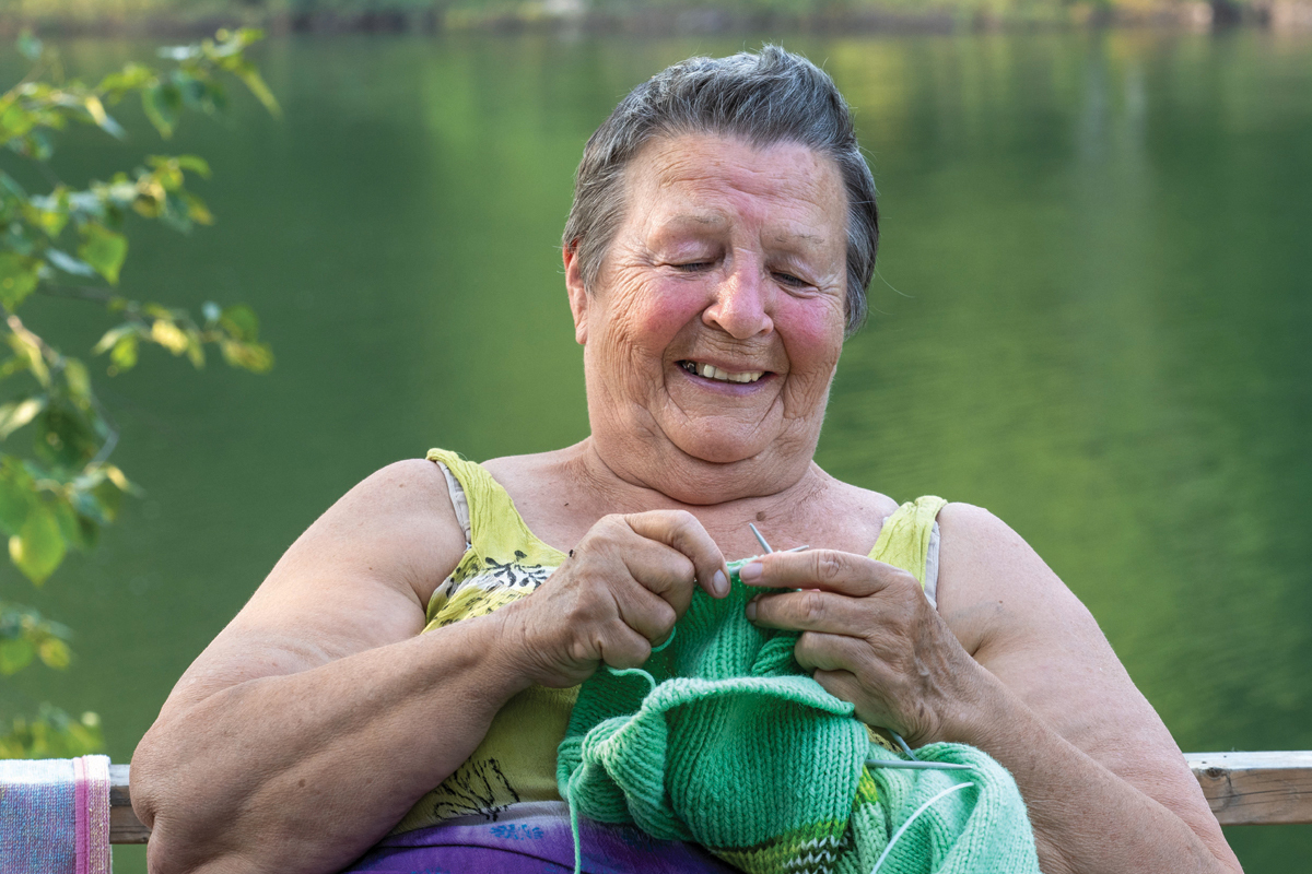 Christina Jones knits near the lake.