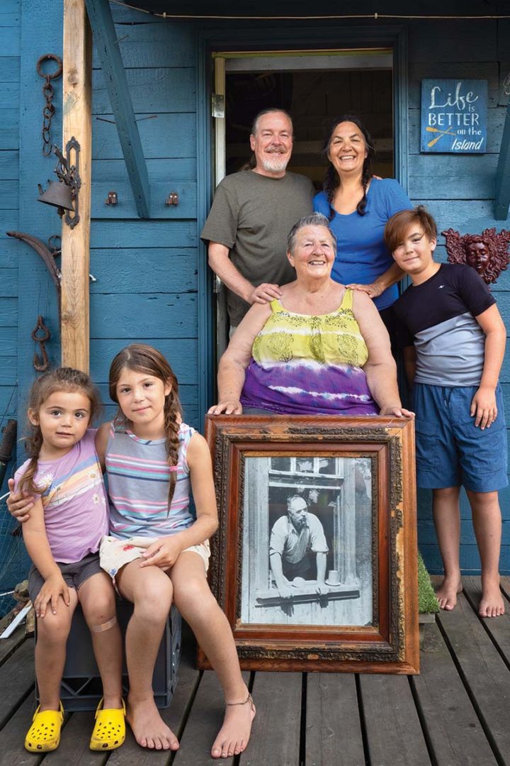 Christina Jones holds a photo of her grandfather surrounded by her family.