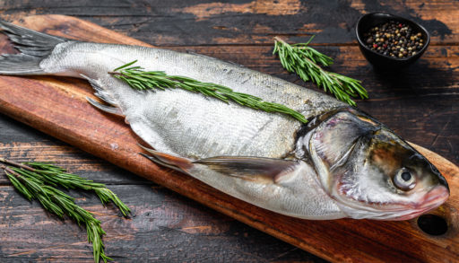 silver carp on a chopping board with herbs asian carp