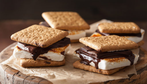 Homemade s'mores arranged on brown waxed paper