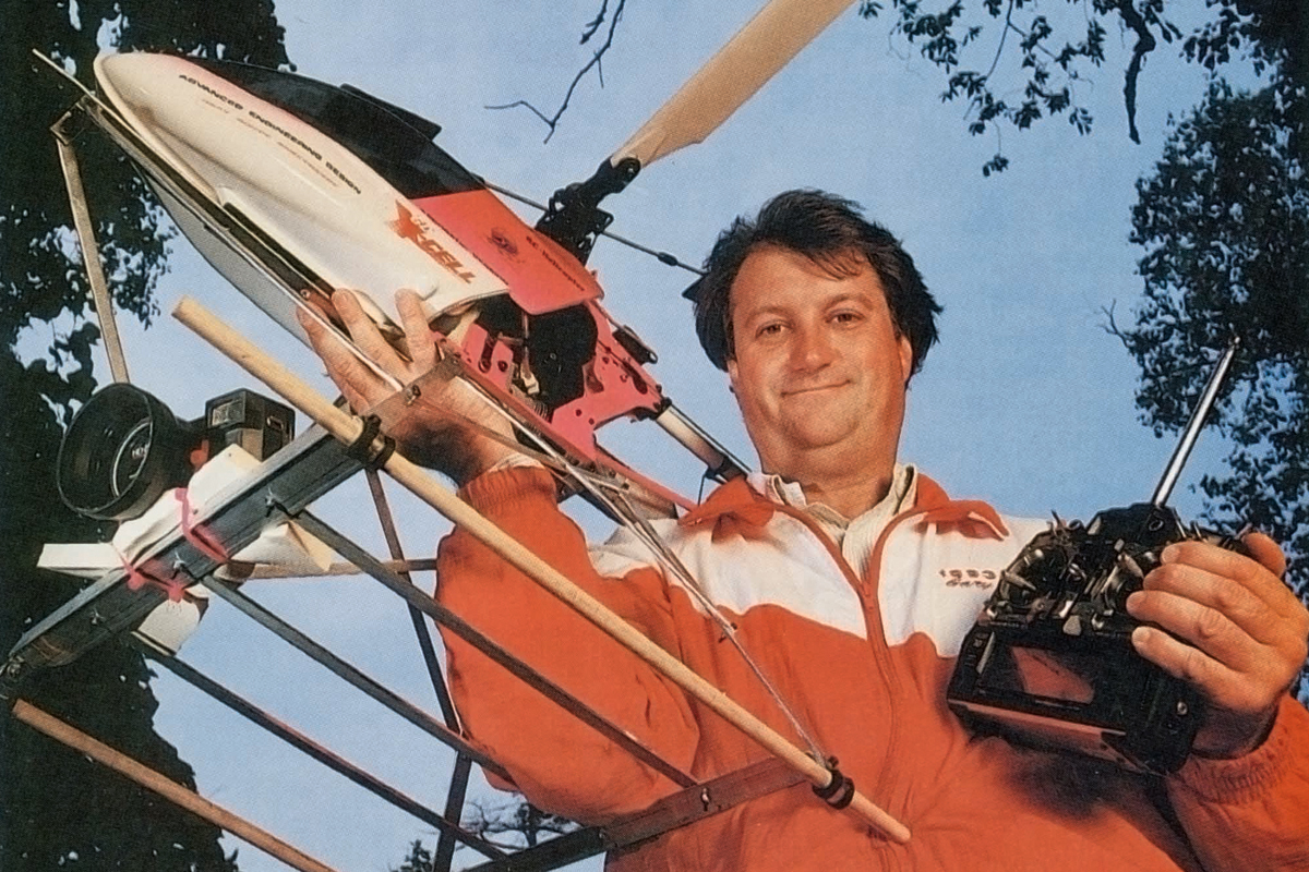 a man holding a remote control helicopter