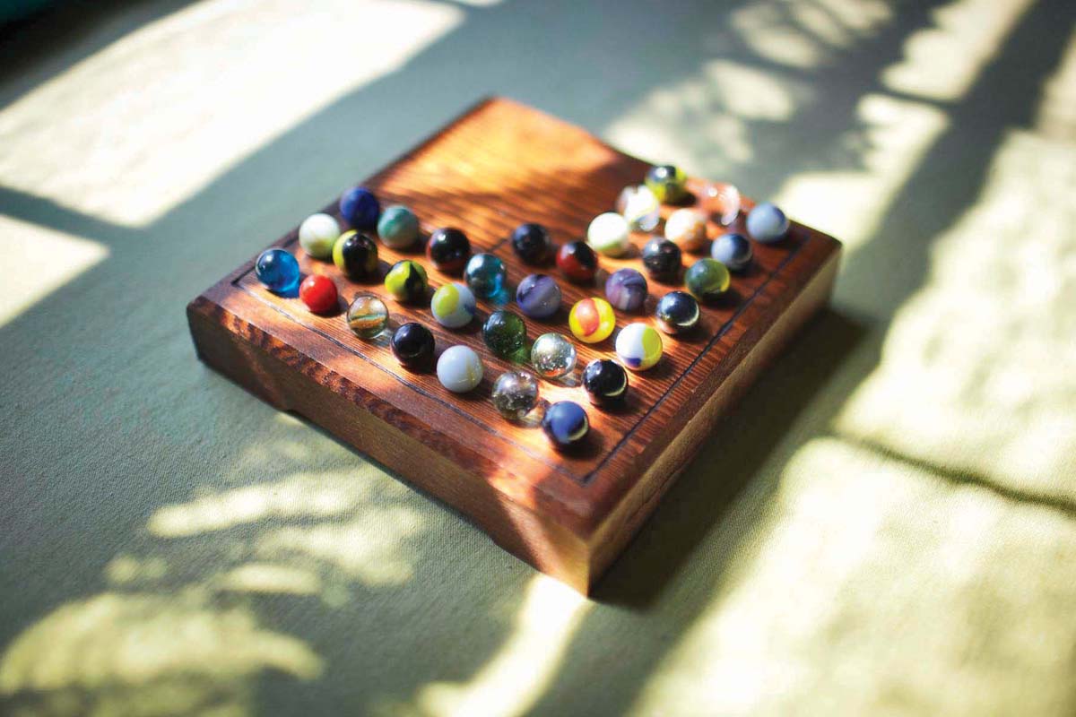 a collection of marbles with shadows dancing over them