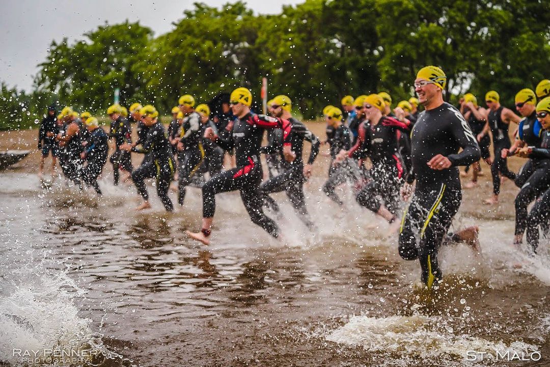 Participants enter the water in St. Malo for their endurance racing event.