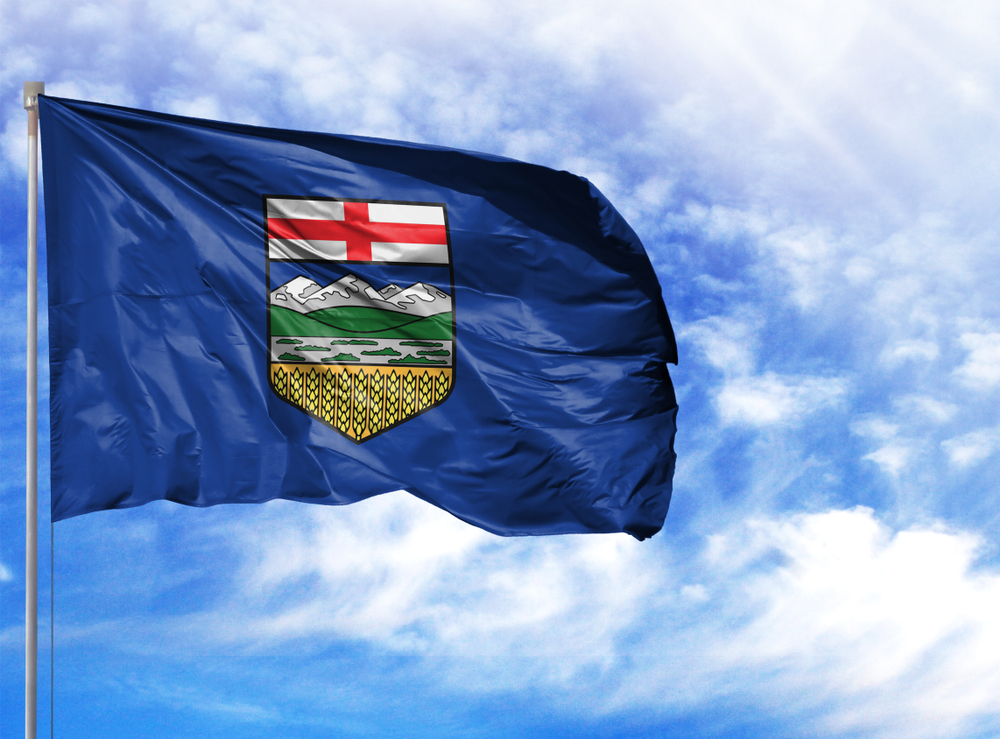 Alberta flag on a flagpole against the blue sky