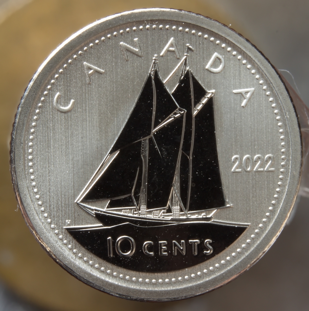 A Canadian dime against a wood background