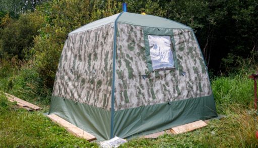 A tent sauna standing in a field