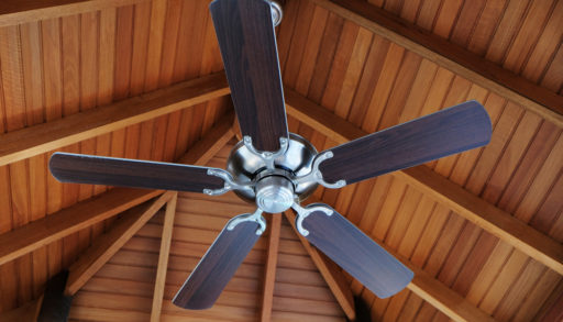A ceiling fan mounted to a wood ceiling
