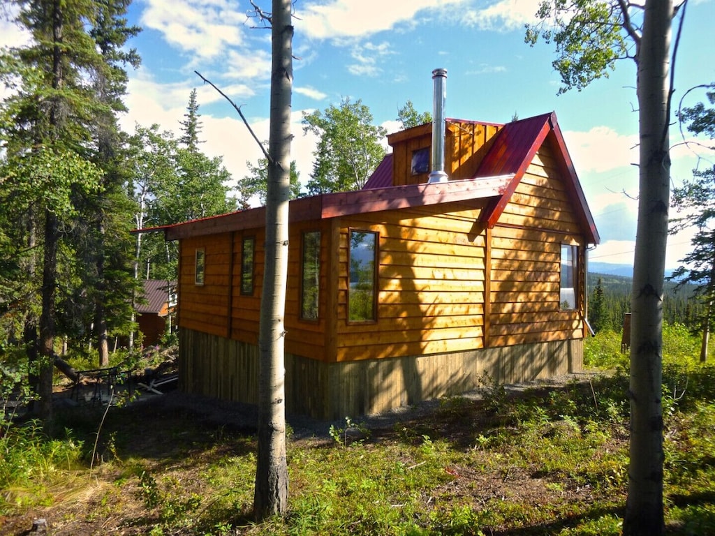 cabin exterior surrounded by trees