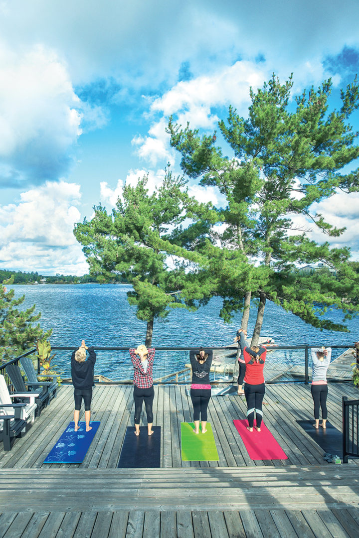 people doing yoga on the back deck of The Hive overlooking Georgian Bay