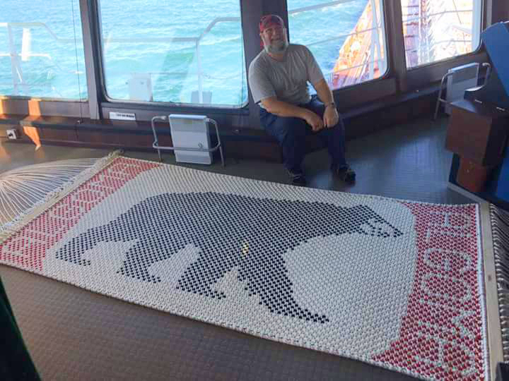Mark Hurst poses with a hammock he made of the Algoma bear