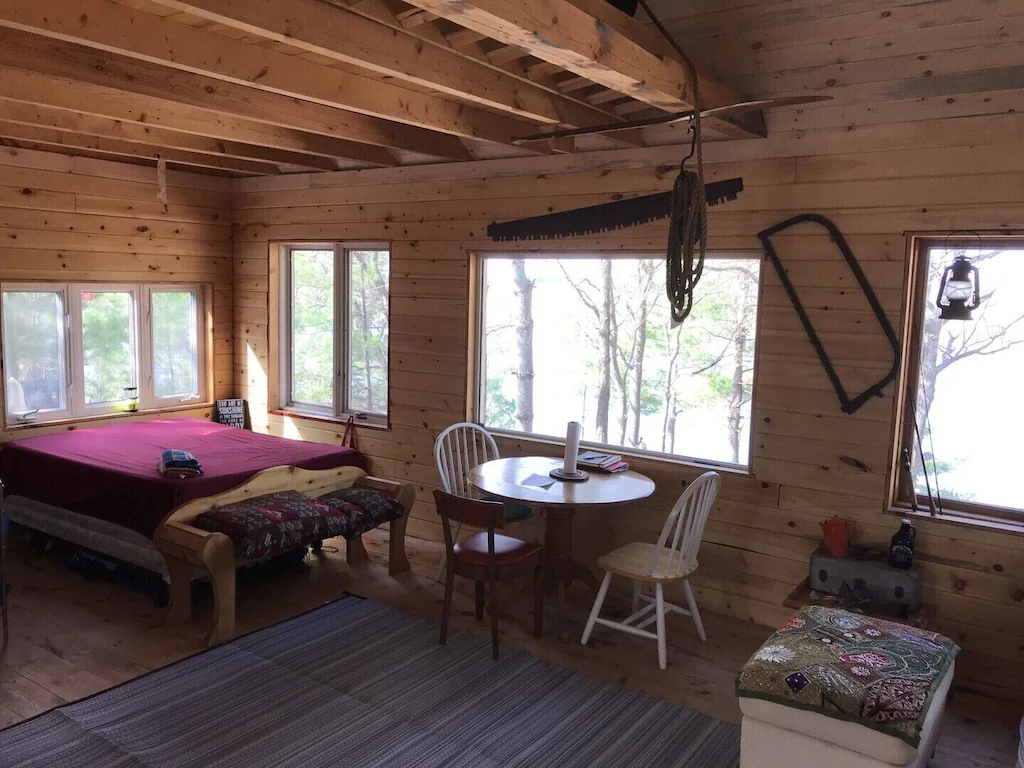 Open-concept area with bed and table and chairs