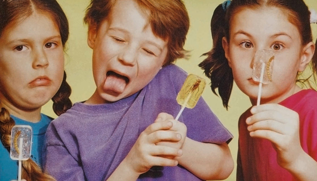 kids posing with bug-infused lollipops