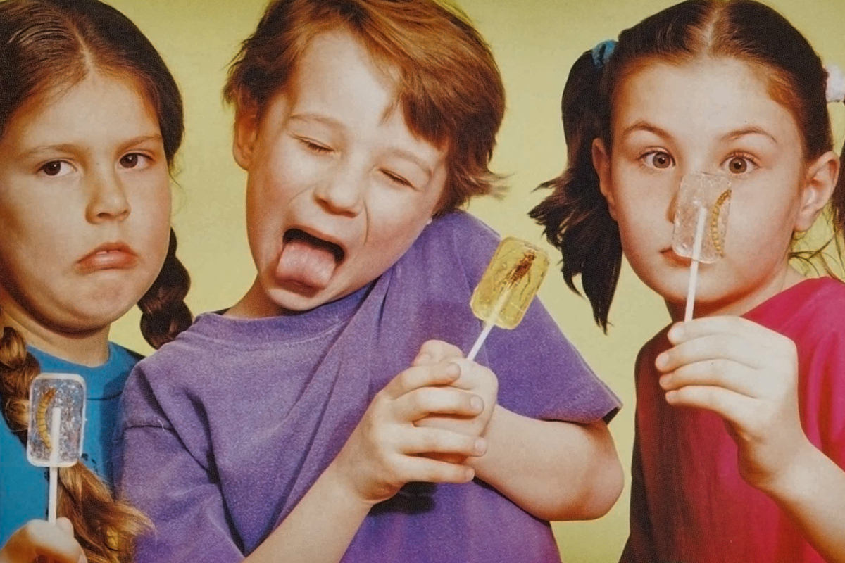 kids posing with bug-infused lollipops