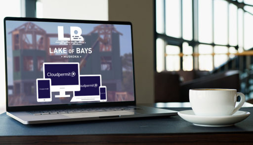 Lake of Bays online building permit software on a laptop on a desk with a cup next to it