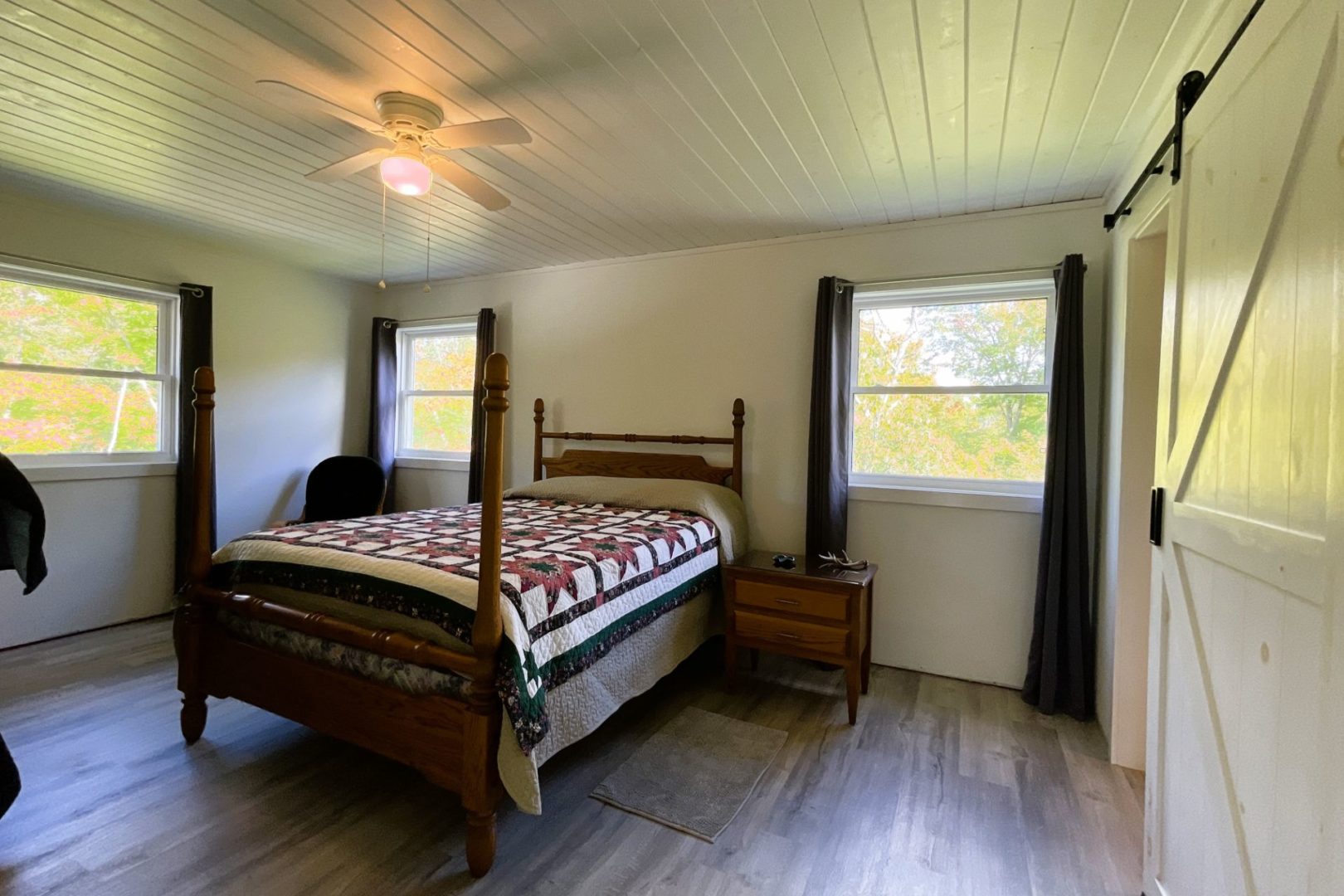 spacious and bright bedroom with a queen bed in it