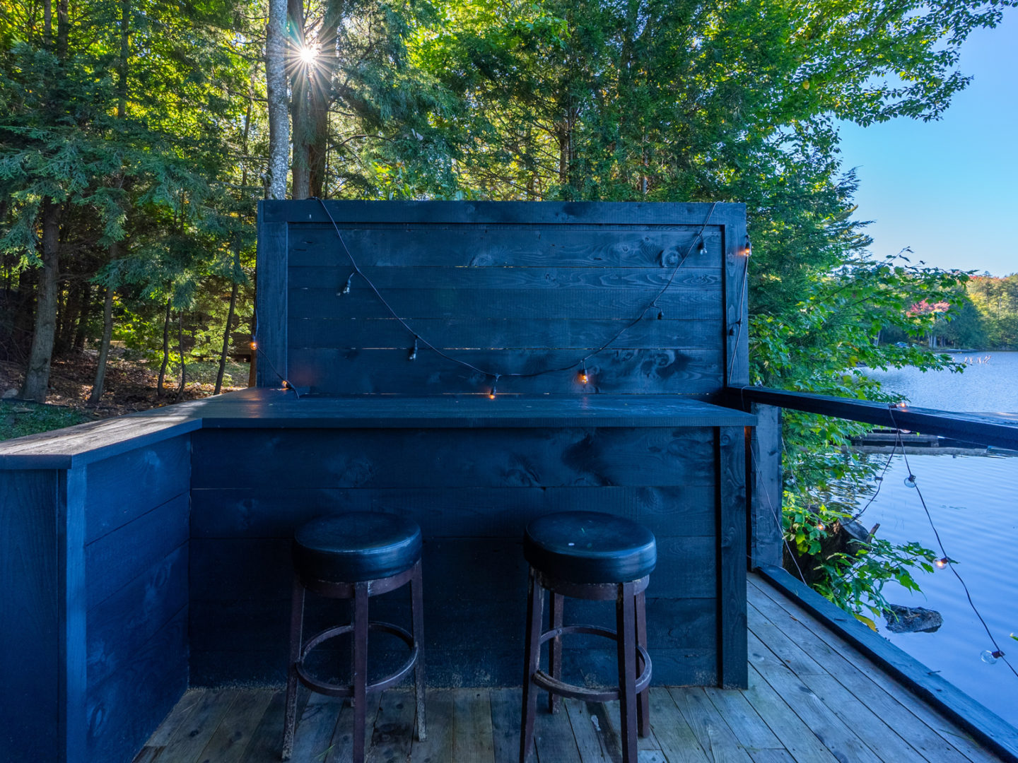 A small bar area looking out over a lake.