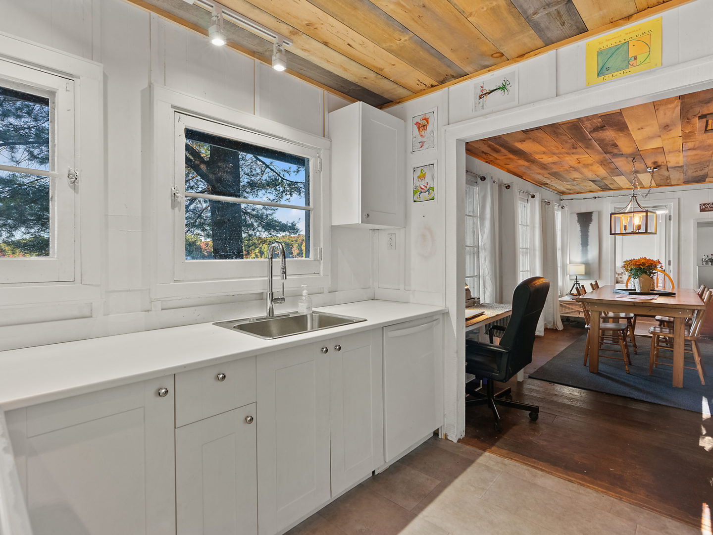 A kitchen area with a sink, leading into a living room.
