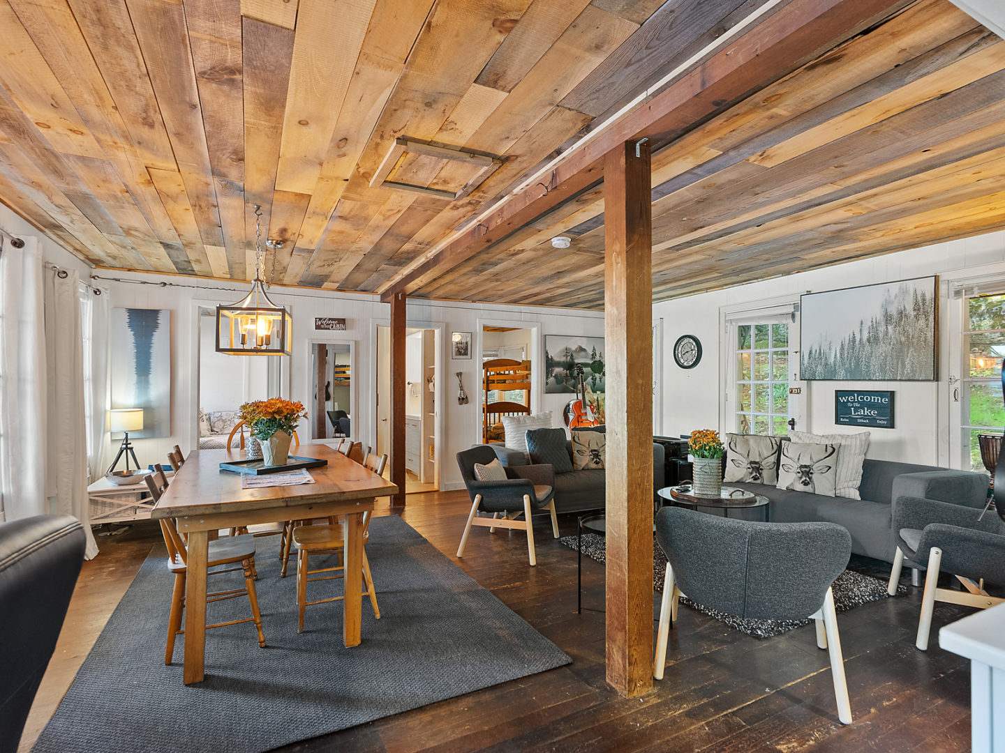 An open concept living space with a dining room table on one side and living room couches on the other.