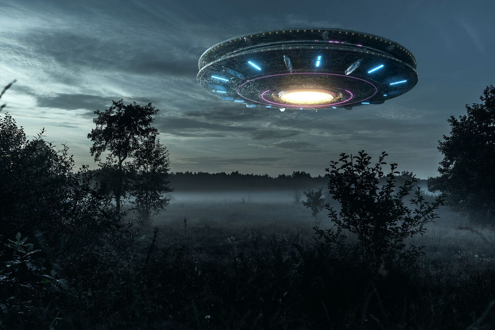 An alien UFO hovering above a field
