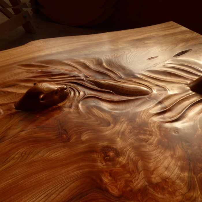 A carving of otters swimming