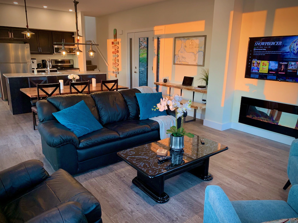 Black couch and fireplace in living space