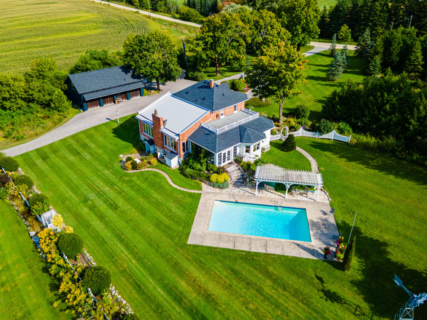A large, secluded property with a big country home and a pool in the backyard.